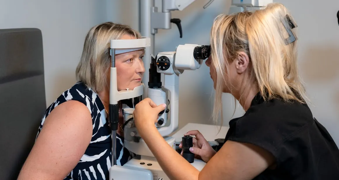 An optometrist carrying out an eye examination at the practice